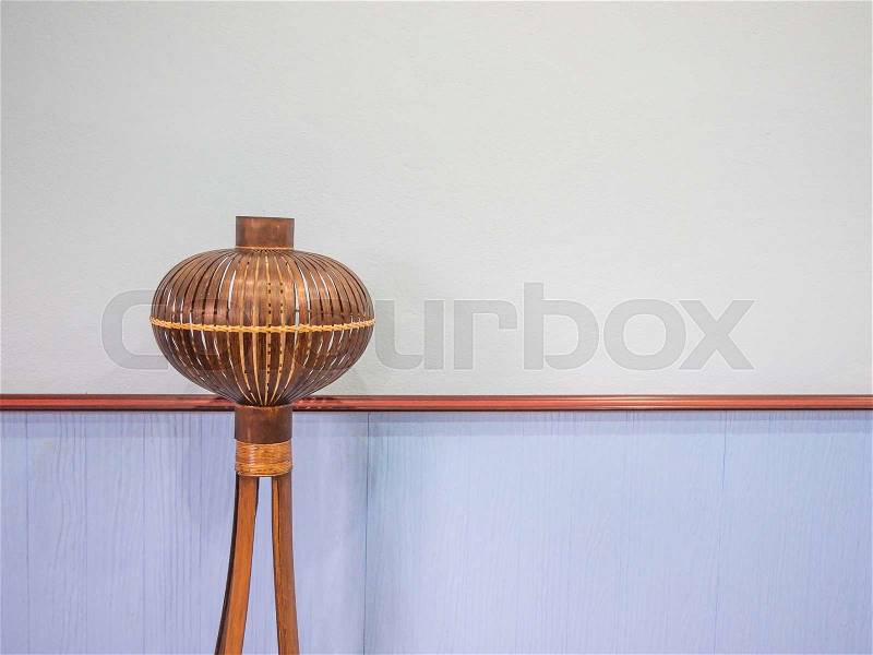 Wood lamp placed in front of a blue wall, stock photo