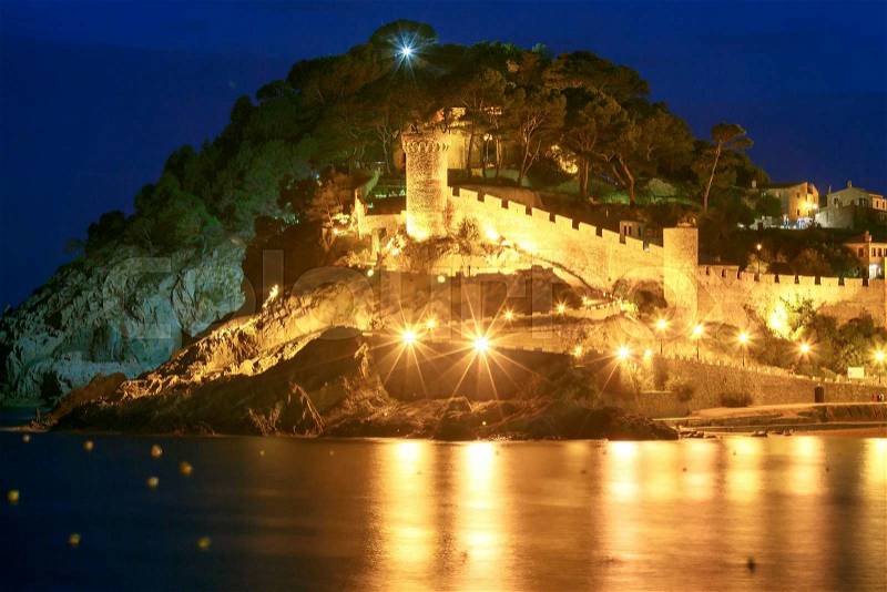 Night view of ancient fortress and Badia de Tossa bay in Tossa de Mar on Costa Brava, Catalunya, Spain, stock photo