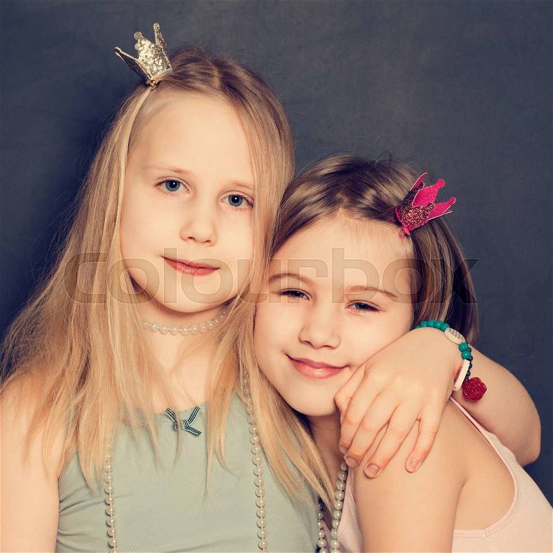 Young smiling girls hugging, stock photo