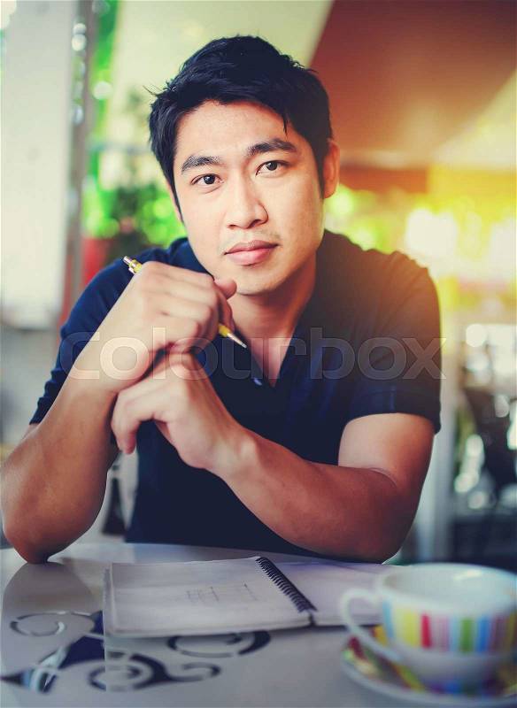 Happy young Asian business man thinking, stock photo