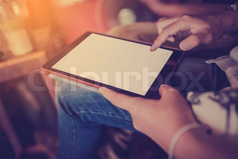 Man using tablet, close-up, in the cafe, stock photo