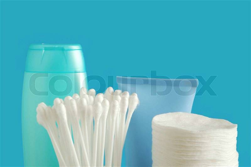 Cotton buds and pads on blue background, stock photo
