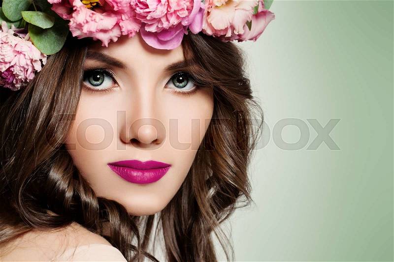 Beautiful Girl with Flowers. Face Closeup. Makeup and Hairstyle, stock photo