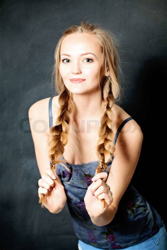 Young Beautiful Girl with Blond Braids. Natural Makeup and Fashion Hairstyle, stock photo