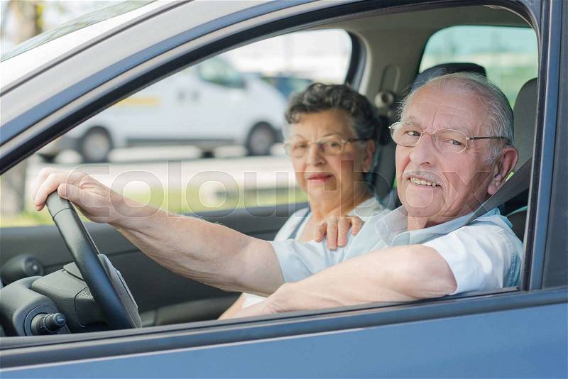 Elderly couple in the car, stock photo