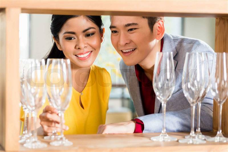 Asian couple buying stuff in furniture store, stock photo