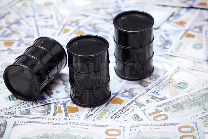 Oil drums on US dollars background, stock photo