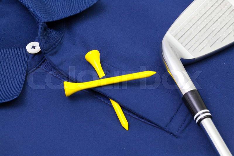 Detail of blue polo shirt and golf equipments, stock photo