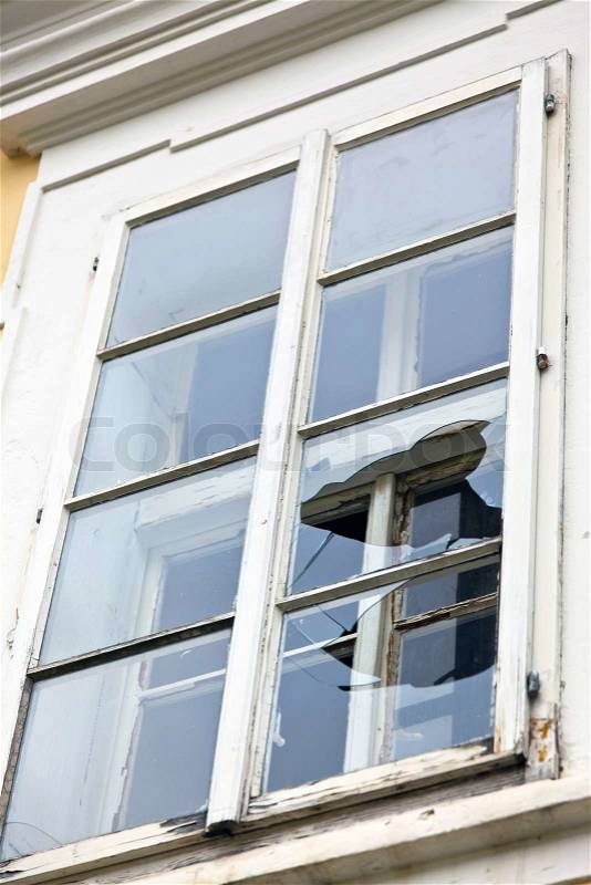 A window with a broken window pane. Broken glass, stock photo