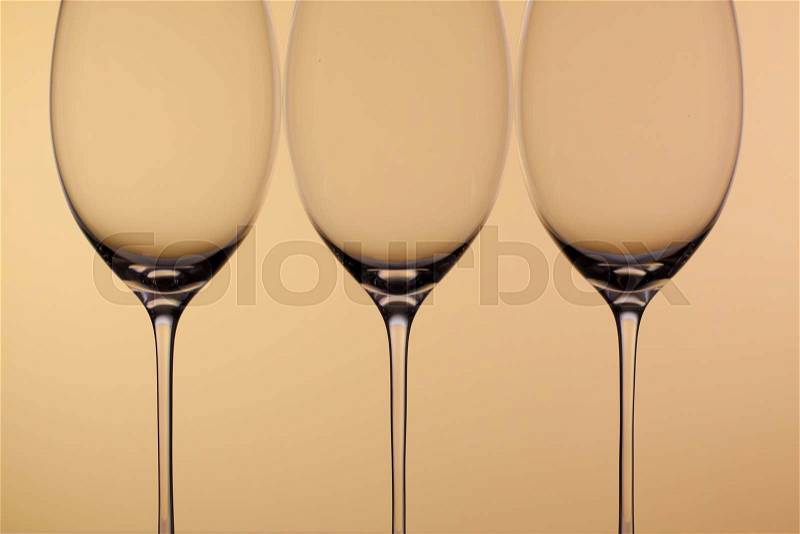 Three empty glasses of wine on a clean background, stock photo