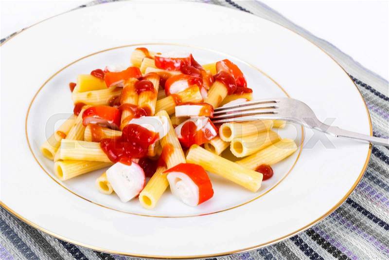 Pasta with Ketchup and Crab Sticks Studio Photo, stock photo