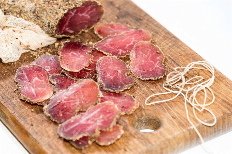 Various sliced meats on wooden serving board. Ham, pork or beef. Preparing for dinner. Selective focus, stock photo