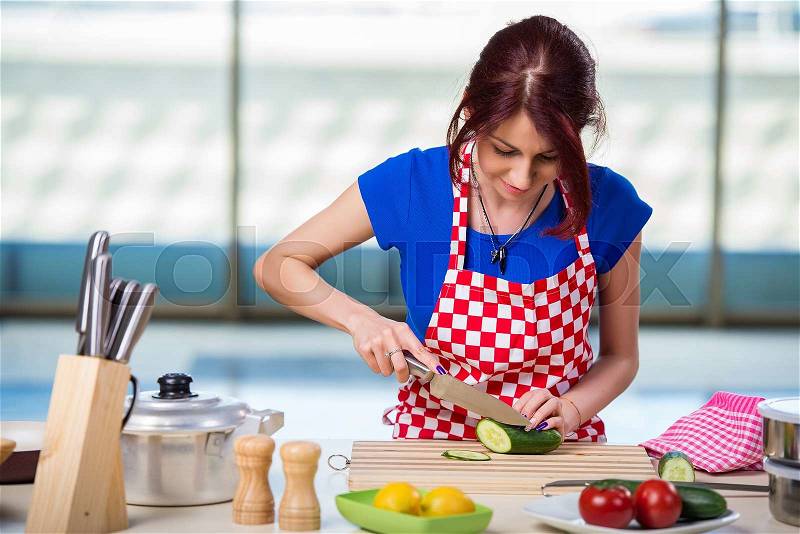 Young cook working in the kitchen, stock photo