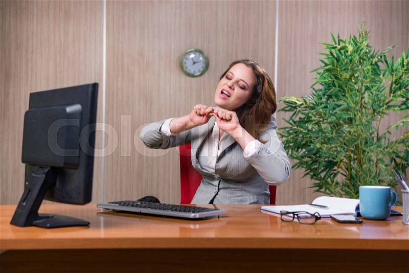 Businesswoman under stress working in the office, stock photo