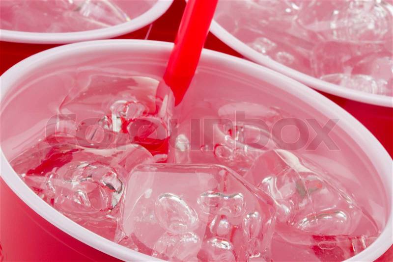 Water and ice in a red disposable cup, stock photo