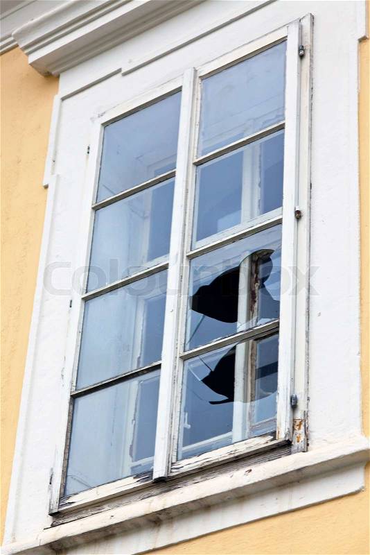 A window with a broken window pane. Broken glass, stock photo