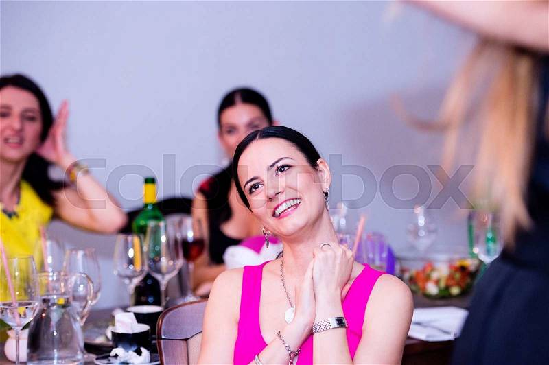 Cheerful bride and happy bridesmaids celebrating hen party with drinks. Women enjoying a bachelorette party, stock photo