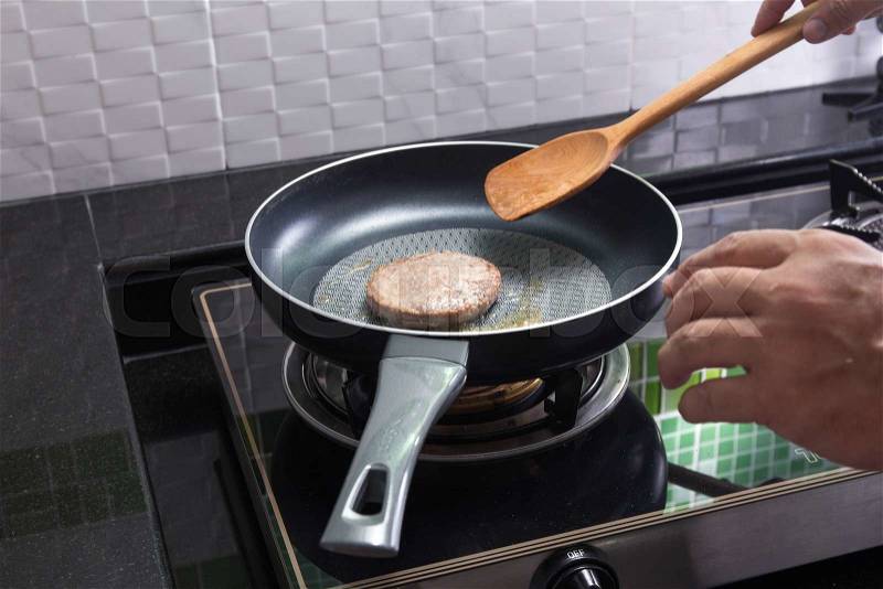 Beef Burger deep fried in the pan / cooking Hamburger concept, stock photo
