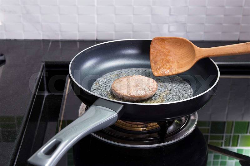 Beef Burger deep fried in the pan / cooking Hamburger concept, stock photo
