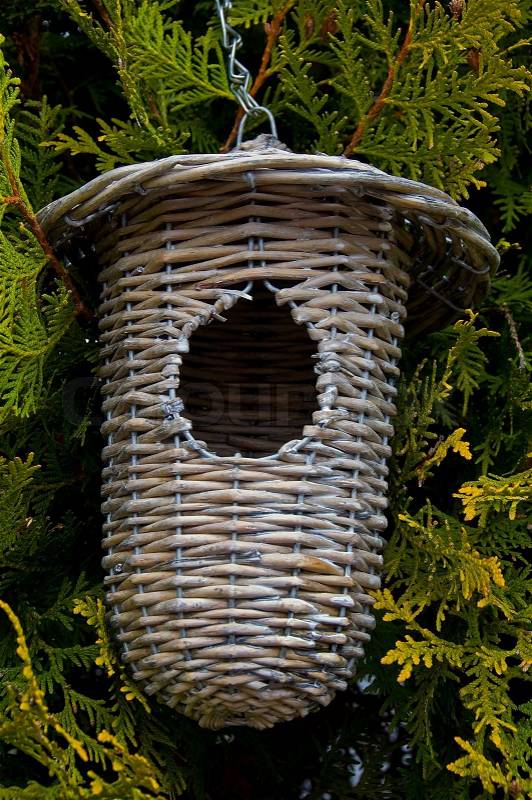 A modern birds house made of wicker, stock photo