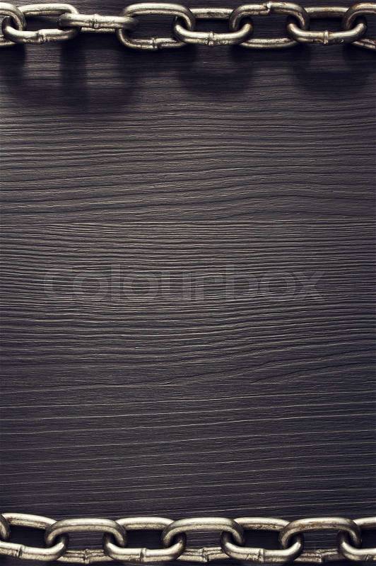 Metal chain on wooden background, stock photo