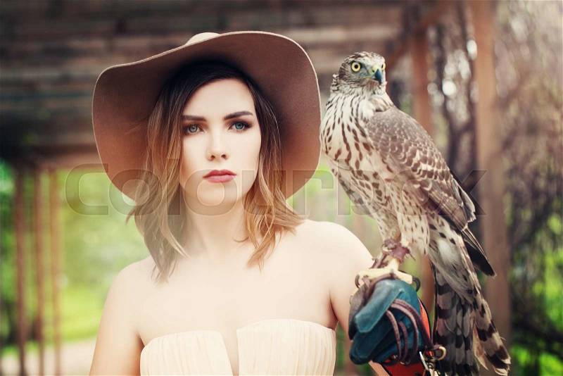 Glamorous Lady in Vintage Hat with Bird, stock photo