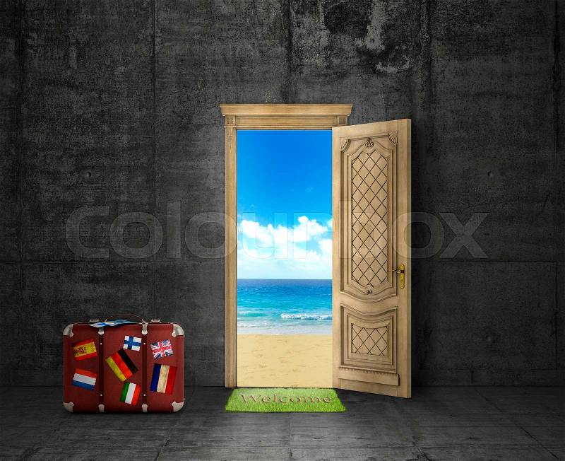 Concept of travel. Door with picture of sand beach, ocean and sky on concrete wall background. Next to the door is packed suitcase and tickets. Concept of recreation, stock photo