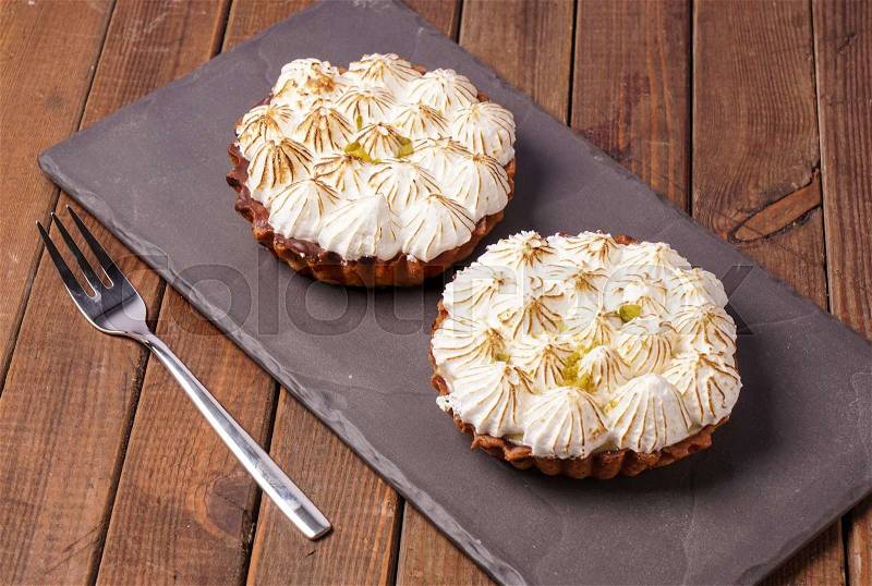 Two Lemon meringue Pie with lime zest, stock photo