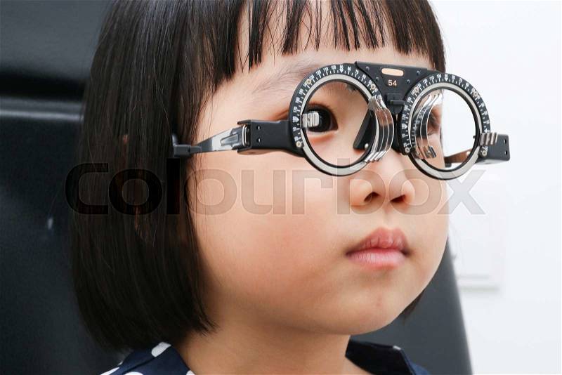 Asian Little Chinese Girl Doing Eyes Examination in isolated White Background, stock photo