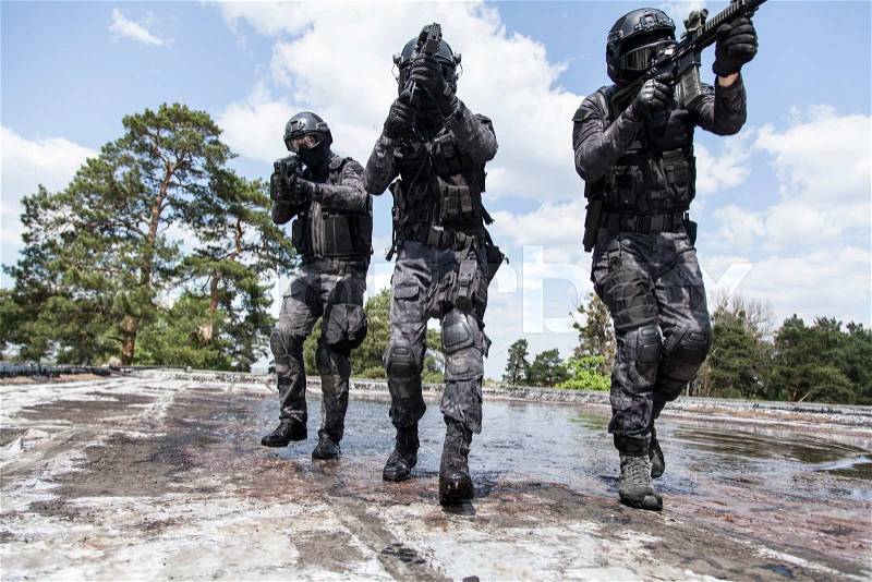 Spec ops police officers SWAT in action in the water, stock photo