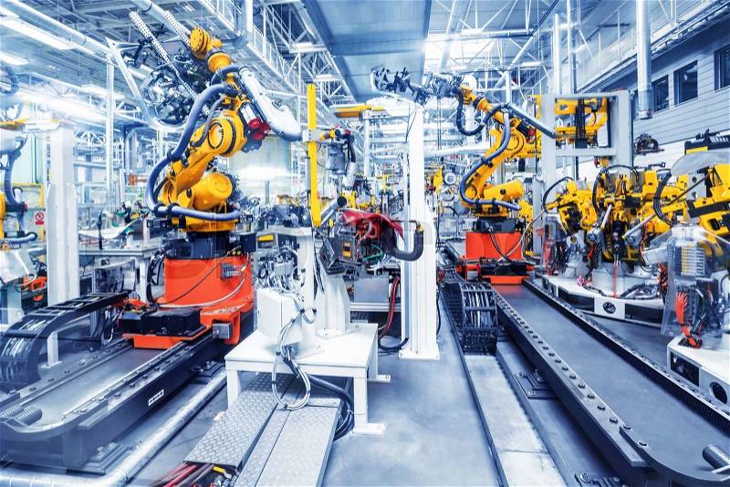 Robotic arms in a car plant, stock photo