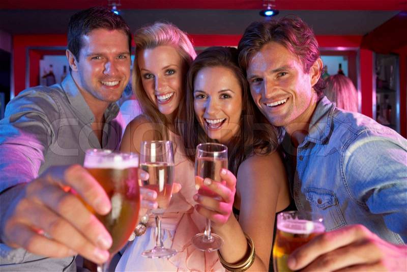 Group Of Young People Having Fun In Busy Bar, stock photo