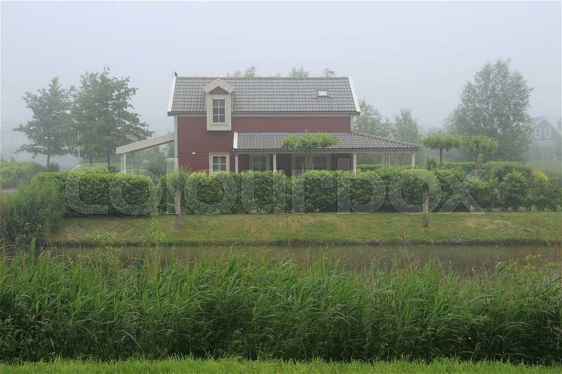 A detached house in fog to hire in all seasons in the holiday park at the country side, stock photo
