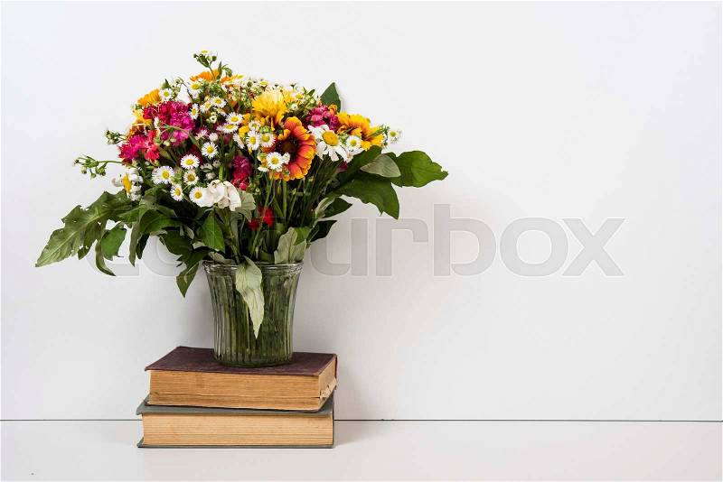 Interior home decor with flowers and books, simple summer decor with copyspace, stock photo