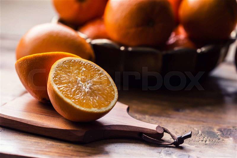 Fresh oranges. Cut oranges. Pressed orange manual method. Oranges and sliced oranges with juice and squeezer, stock photo