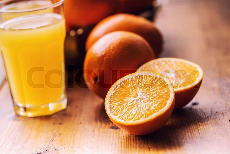 Fresh oranges. Cut oranges. Pressed orange manual method. Oranges and sliced oranges with juice and squeezer, stock photo