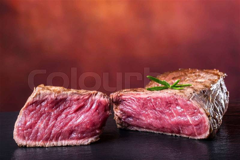 Grill beef steak. Portions thick beef juicy sirloin steaks on grill teflon pan or granite board, stock photo