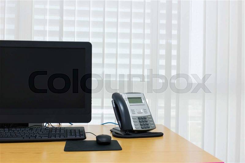 Telephone and computer on table work of room service office, stock photo