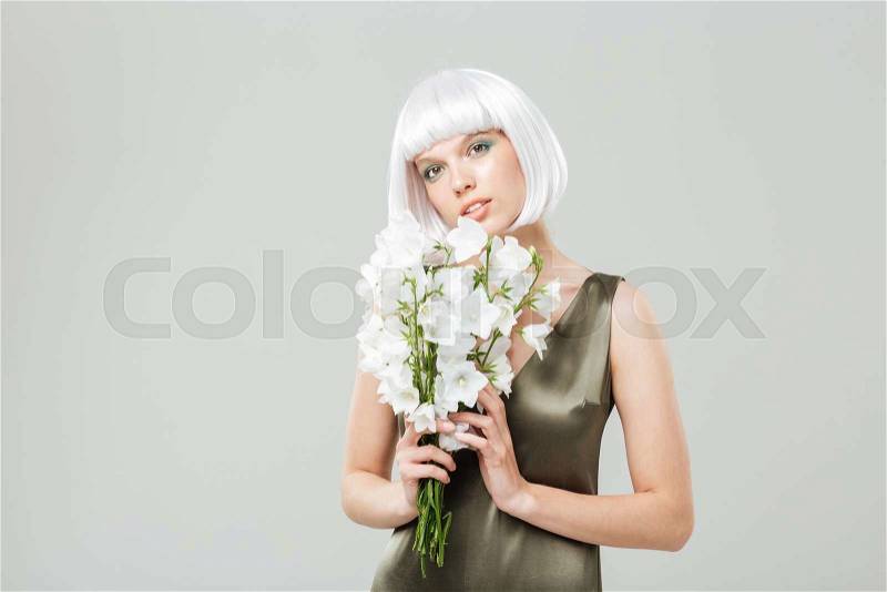Portrait of sensual attractive young woman with bouquet of flowers, stock photo