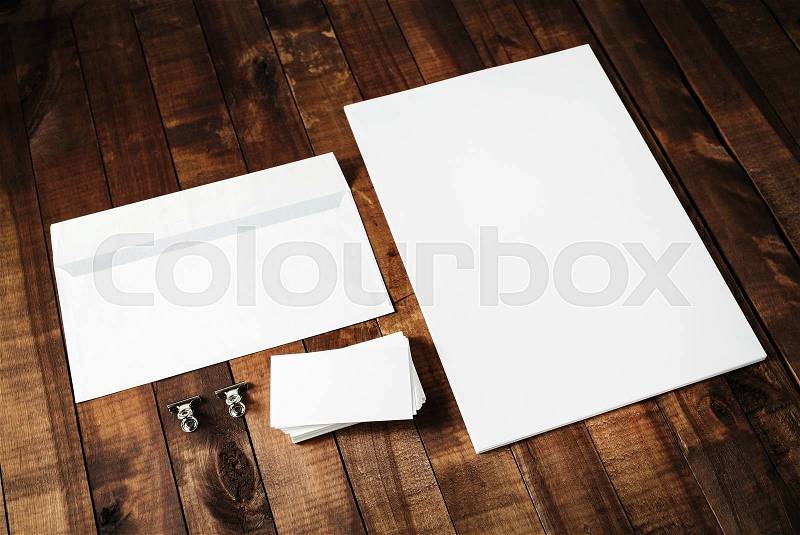 Blank letterhead, business cards and envelope. Photo of blank stationery set on vintage wooden table background. Mockup for design portfolios. Blank template for branding identity, stock photo