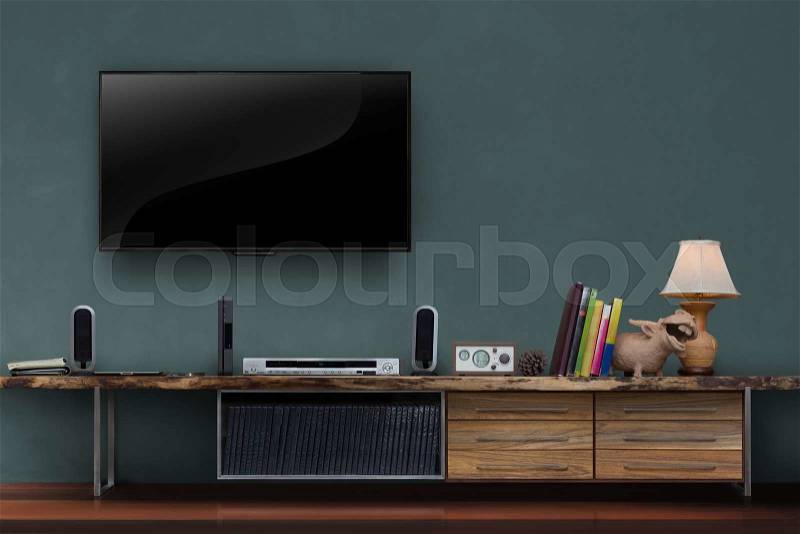 Led tv on dark green wall with wooden table media furniture modern loft style in living room, stock photo