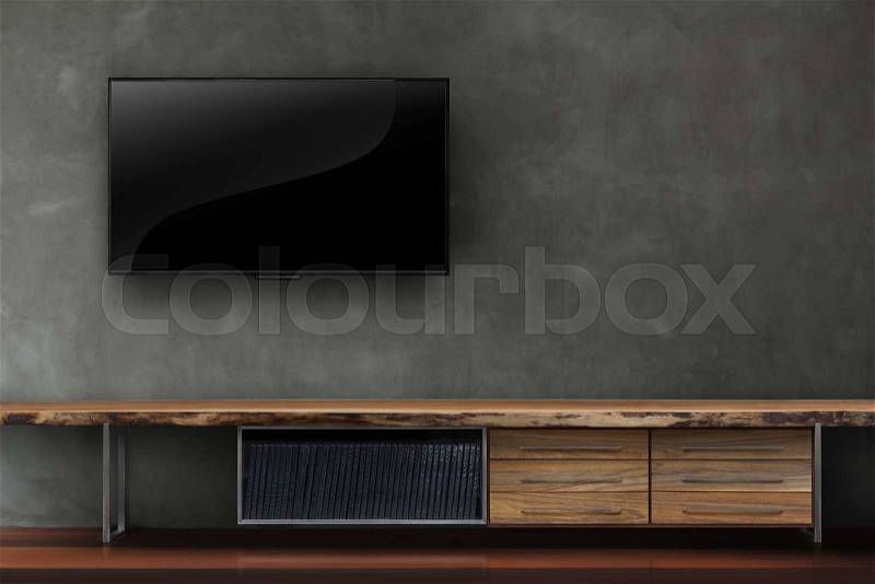 Led tv on concrete wall with wooden table media furniture modern loft style in living room, stock photo