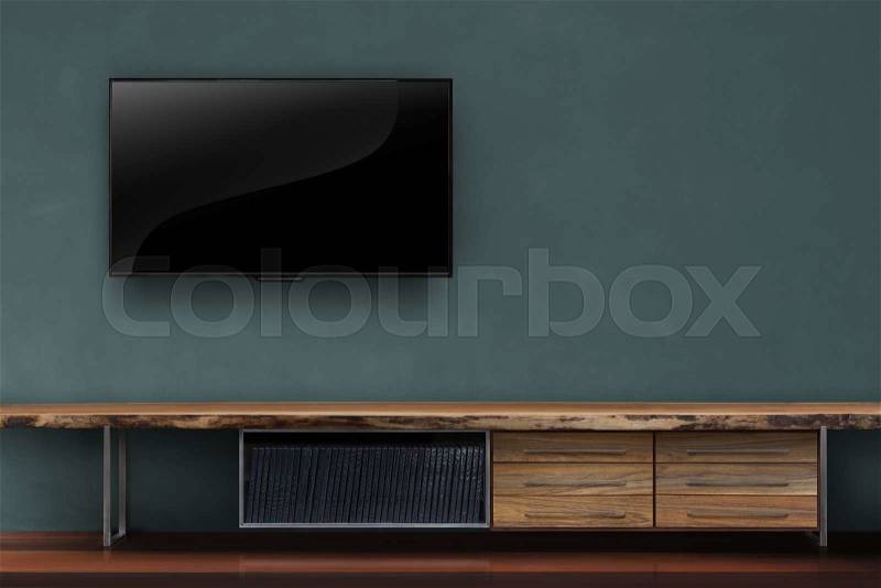 Led tv on dark green wall with wooden table media furniture modern loft style in living room, stock photo