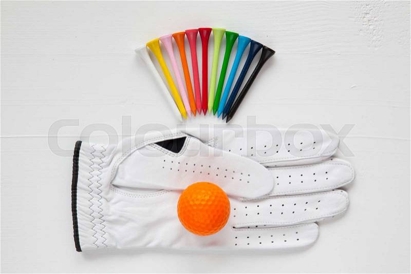 Different golf equipments on the white table, stock photo