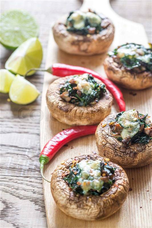 Baked mushrooms stuffed with spinach and cheese, stock photo