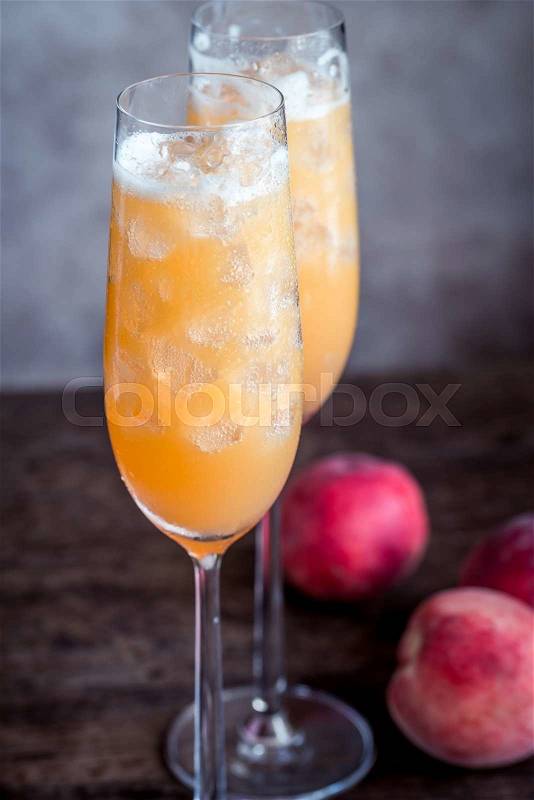 Two bellini cocktails with fresh peaches, stock photo