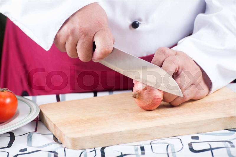 Chef cutting red onion before cooking / cooking spagetti concept, stock photo