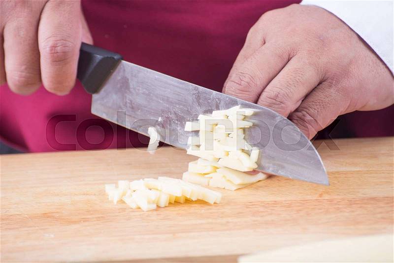 Closed up Chef cutting cheese with knife before cooking / cooking spaghetti concept, stock photo