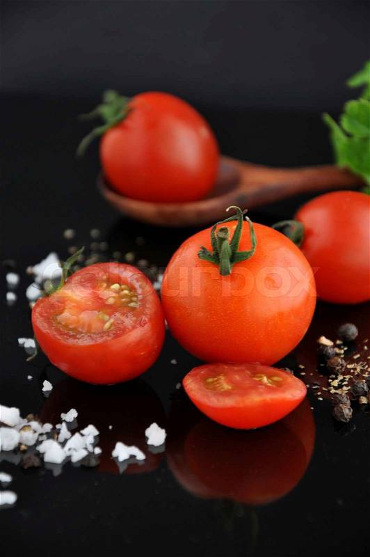 Juicy fresh cherry tomato with salt and black pepper, stock photo