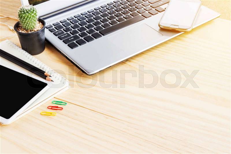 Office desk table with laptop computer, note book and smart phone. Top view with copy space, stock photo